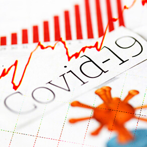 Word Covid-19 written across chart, virus cell in red, red lines, red medical graph