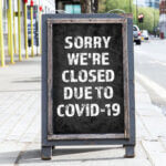 Store sign with words sorry were closed due to COVID-19
