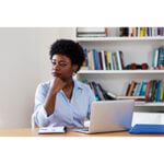 Woman at computer thinking