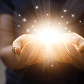 Pair of hands holding illuminated rays of light